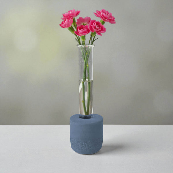 Blue round concrete test tube bud vase with pink flowers