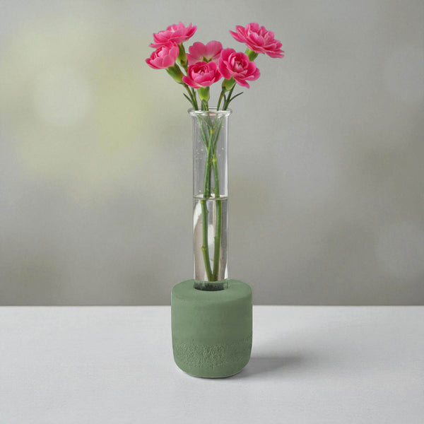 Green round concrete test tube bud vase with pink flowers