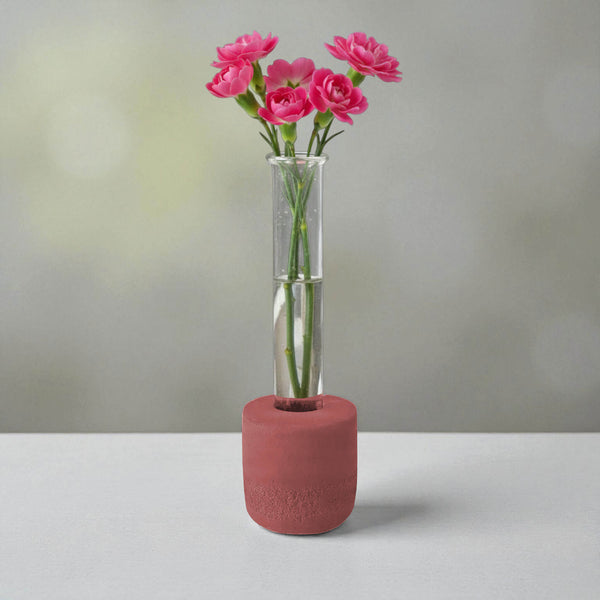 Red round concrete test tube bud vase with pink flowers